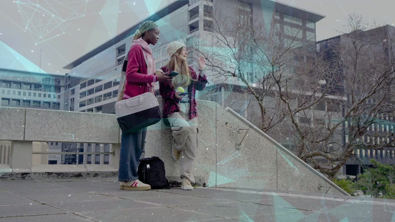 Two students sharing phone, one reacting and pointing, showing campus info with turquoise overlay