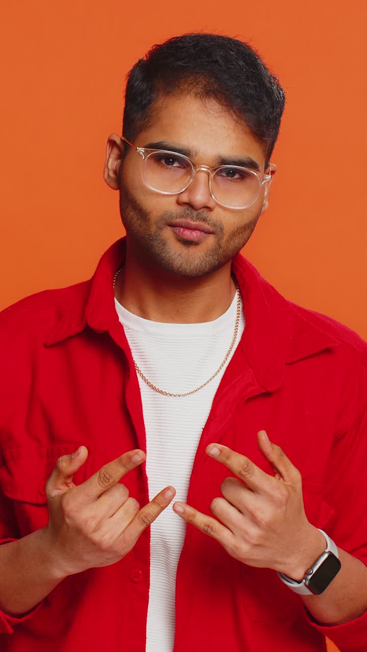 Happy indian man showing rock n roll gesture by hands cool sign crazy expression dancing victory win