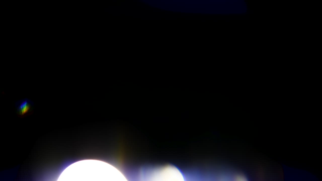 Beautiful, stunning light reflections and anamorphic blue streaks shot on black with high-end cinema anamorphic lens as a background, light leak overlays or transitions for editors
