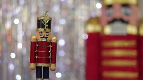 Toy-soldier-nutcracker-next-to-same-huge-figurine-in-bokeh-background