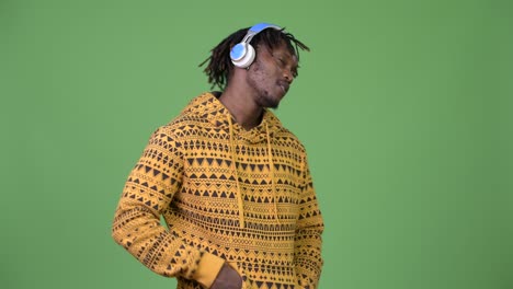 young happy handsome african man smiling while listening to music