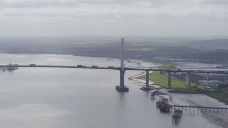 tracking-shot-of-Queen-Elizabeth-II-Bridge-,-Dartford-Thurrock-River-Crossing,-wide-shot