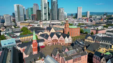 4k aerial drone video of modern skyscrapers overlooking the historic römerberg town square in downtown frankfurt, germany