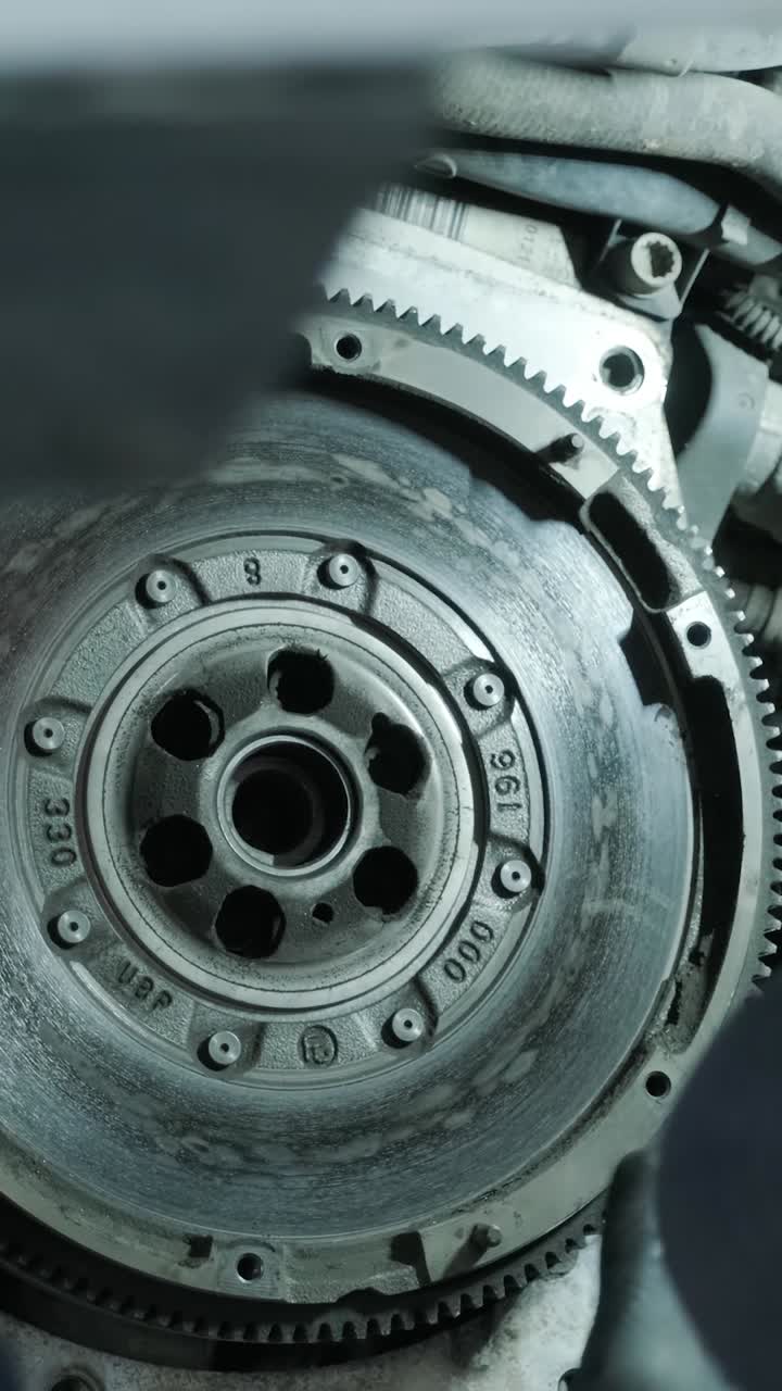Close-up of Mechanic Repairing Car Engine Flywheel