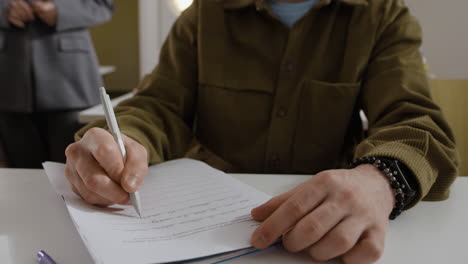 a student writing on paper