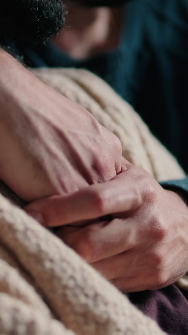 Gay Couple Embracing on Sofa at Home