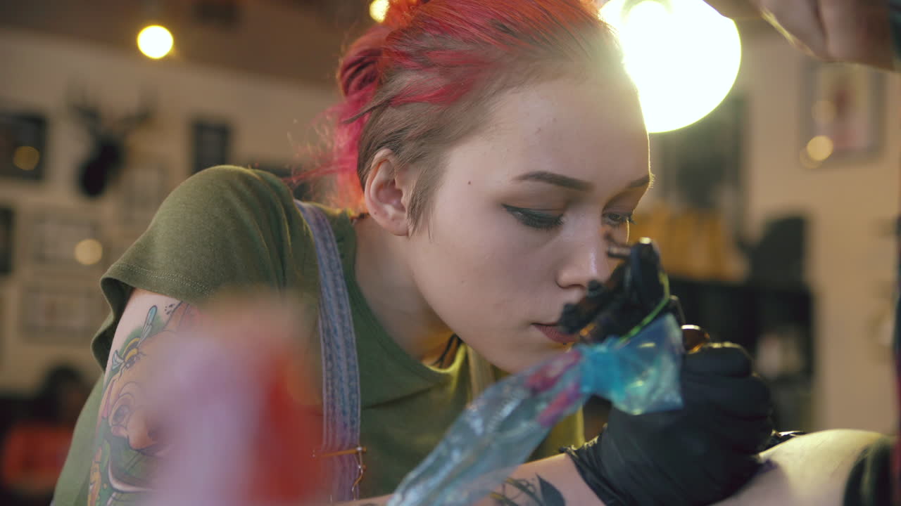 Tattoo artist working on a client