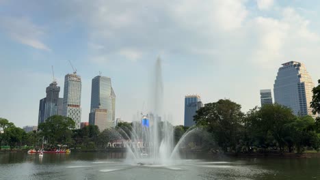 lumphini bangkok thailand park green space water pond, city buildings skyline