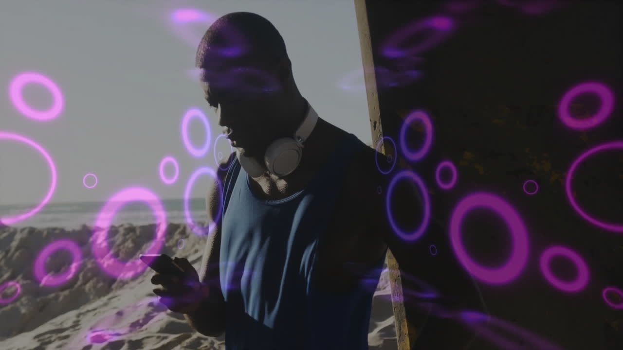 Man checking smartphone on sandy beach, presenting technology with purple circular light overlays