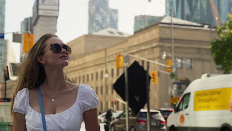 young lady in toronto looking at buildings