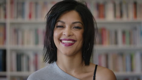 close up portrait happy young hispanic woman laughing enjoying successful education lifestyle independent female student in library bookstore background slow motion