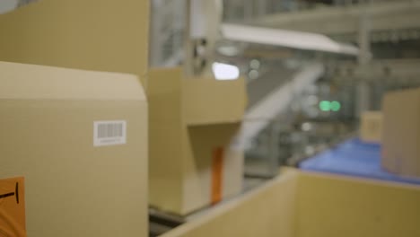 Worker-scans-barcodes-on-packages-in-a-warehouse,-close-up