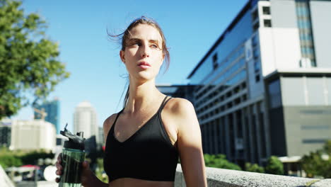 She's-staying-hydrated-throughout-her-workout