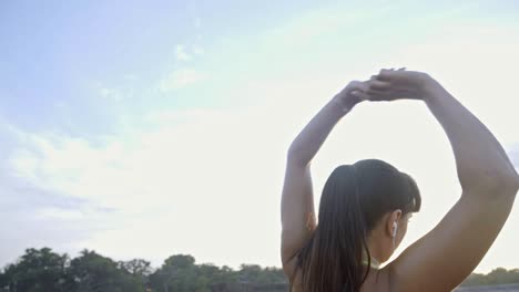 woman warming up on beach before workout