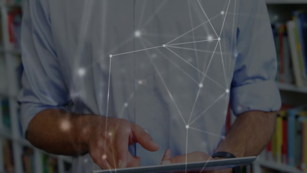 Mid adult man tapping tablet in library, visualizing data network mesh expanding across torso
