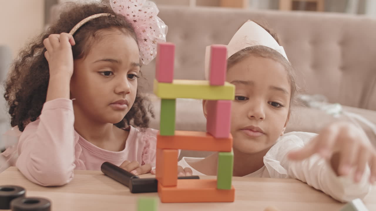 Girls Building Tower with Wooden Bricks