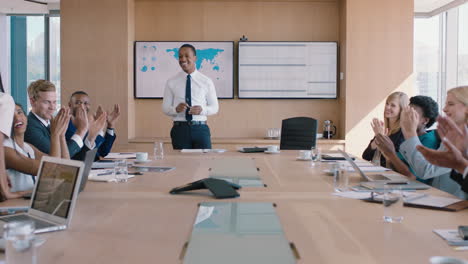 business people celebrating victory team leader man congratulating female executive for successful sales company shareholders clapping hands in office boardroom meeting