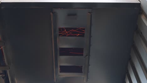 metal construction grill of the dryer with bright fiery sparks that move quickly. close-up of elevator details