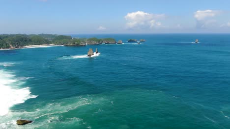 turquoise indian ocean crash on rocks by asmara beach, java, indonesia, aerial