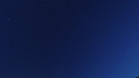 time lapse looking up at clouds passing twinkling stars in the clear night sky