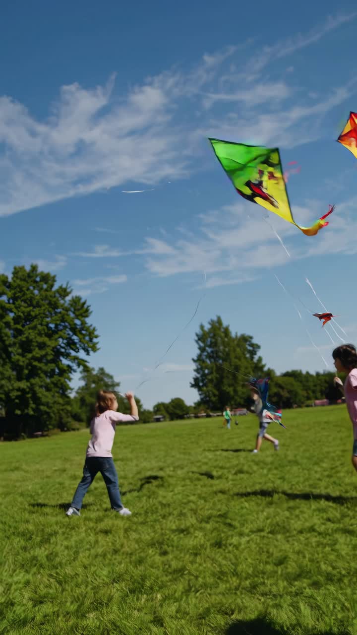 A lively video scene of children flying colorful kites in a sunny park
