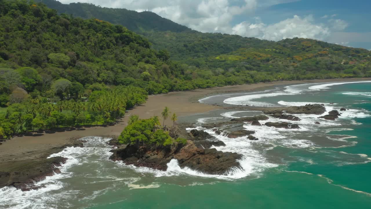 Rock outcrop with green trees on tropical shore of Costa Rica, Amancio