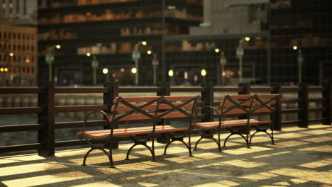 three empty benches in a city park at sunset