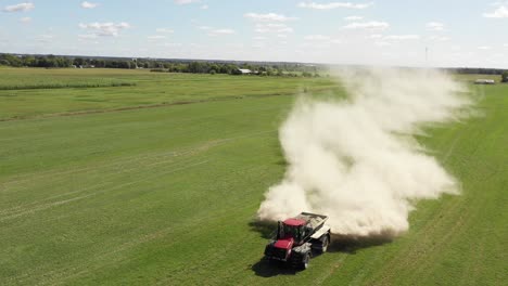 tractor agrícola esparciendo polvo blanco vista giratoria frontal