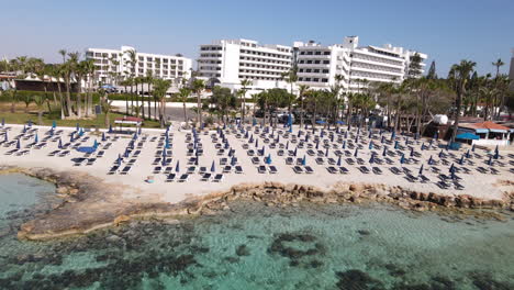 aerial towards nissi beach resort sun loungers next to the seashore, ayia napa cyprus