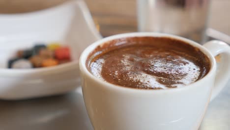 closeup of a cup of turkish coffee with turkish delight