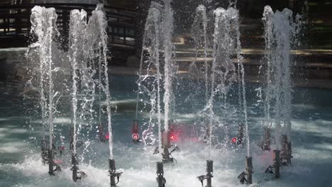 close up view of a fountain in a park with water jets