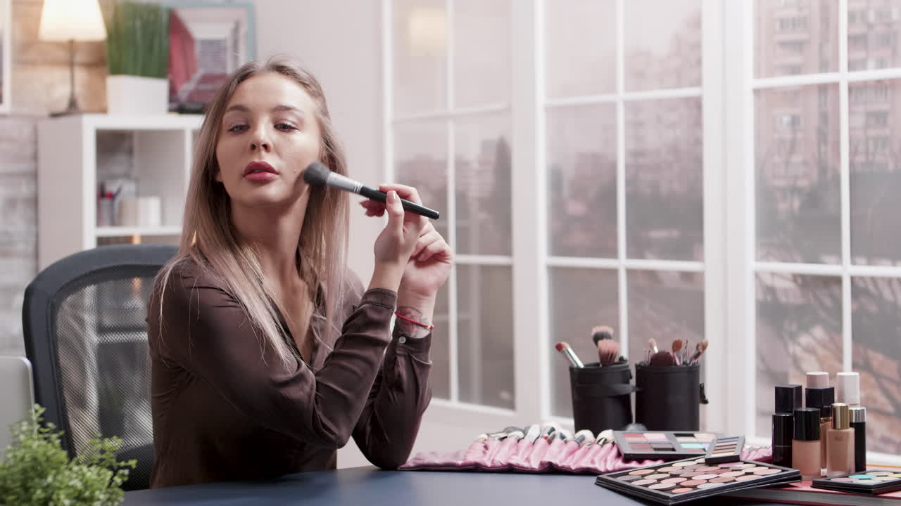 Woman applying makeup at desk