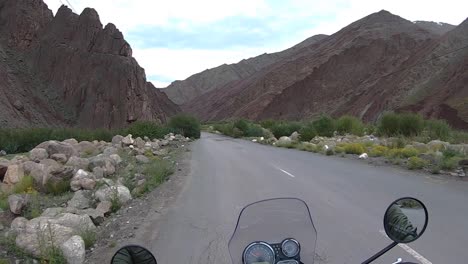 wide angle point of view shot of a biker driving fast and smoothly, but carefully on a foothill curvy mountain road in a remote, isolated area