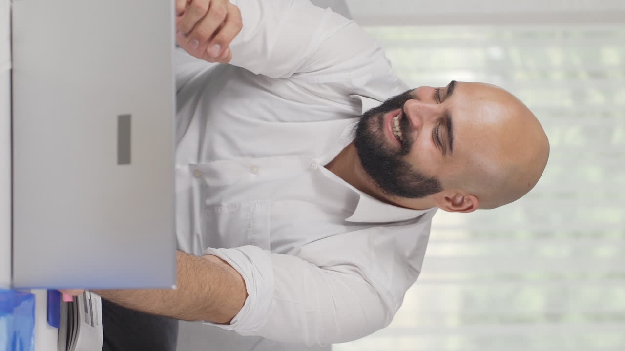 Vertical video of Home office worker man making money and feeling happy.