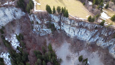 Aerial-descent-of-rock-cliffs-at-Wandfluh-Solothurn,-Switzerland