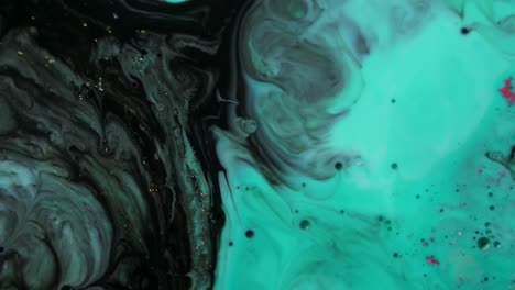 black and teal acrylic chemical reaction. slow motion