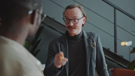 CEO Explaining Business Ideas to Colleagues during Office Meeting