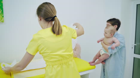 mother with girl being examined by female pediatrician