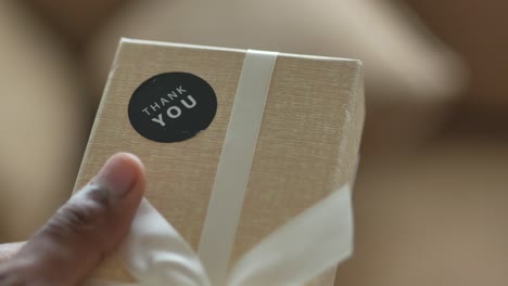 close up of a hand holding a thank you gift