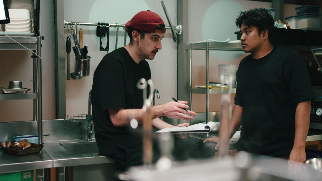 Two Chefs Discussing in a Commercial Kitchen