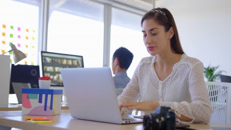 Pretty-Caucasian-female-executive-working-on-laptop-at-desk-4k