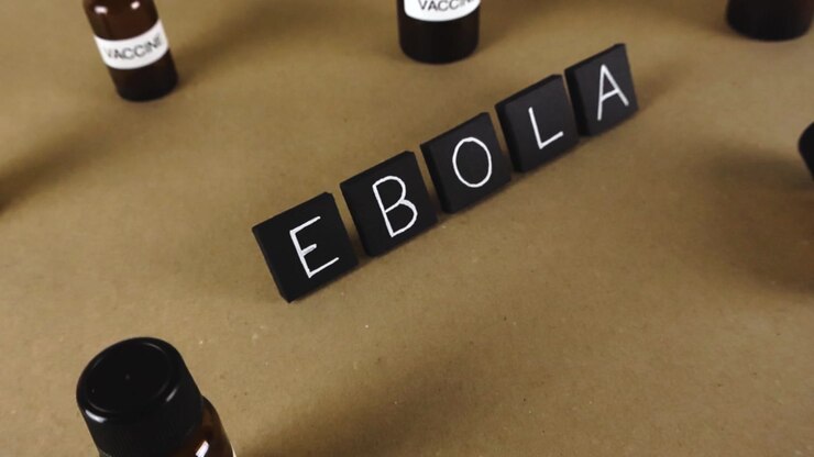 Conceptual video showing the word Ebola made with letter tiles, surrounded by vaccine vials, symbolizing the urgent search for a cure and global health crisis response to the deadly outbreak