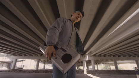 young man posing with stereo