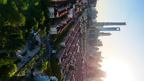 Vertical-revealing-aerial-shot-of-a-beautiful-sunset-over-a-residential-area-in-downtown-Shanghai,-China