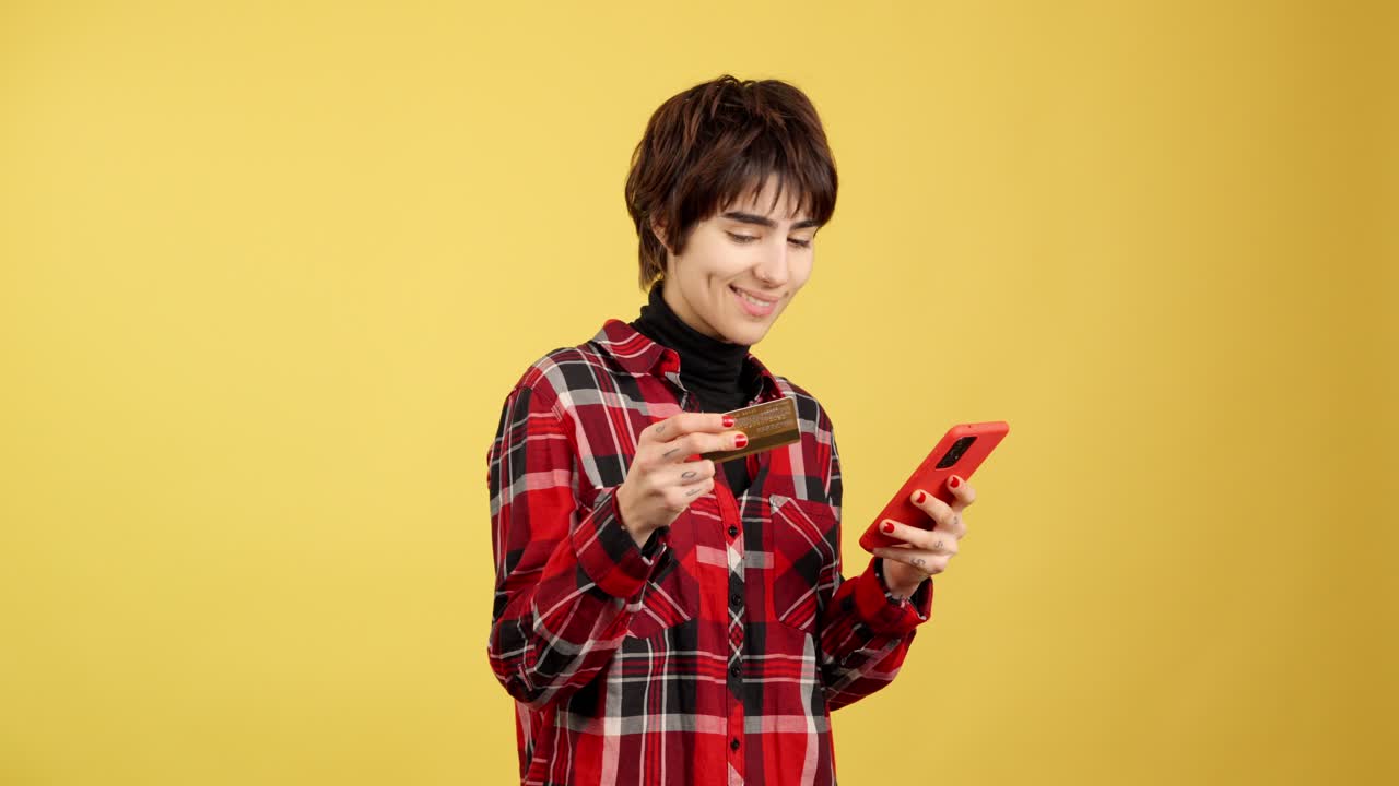 Woman making an online purchase with a credit card and smartphone