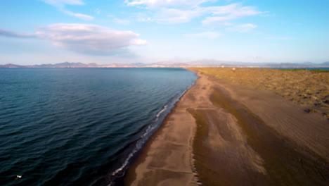 Drone-shot-of-a-beach-level-takeoff-in-the-dunes-of-el-mogote-in-baja-california-sur-mexico