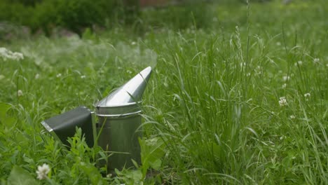bee smoker in a green field