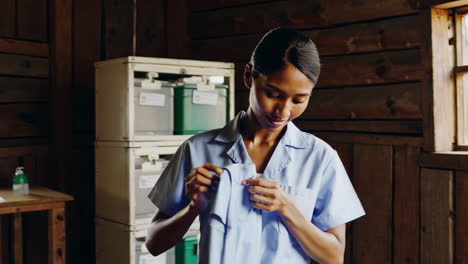woman adjusting uniform in rural clinic