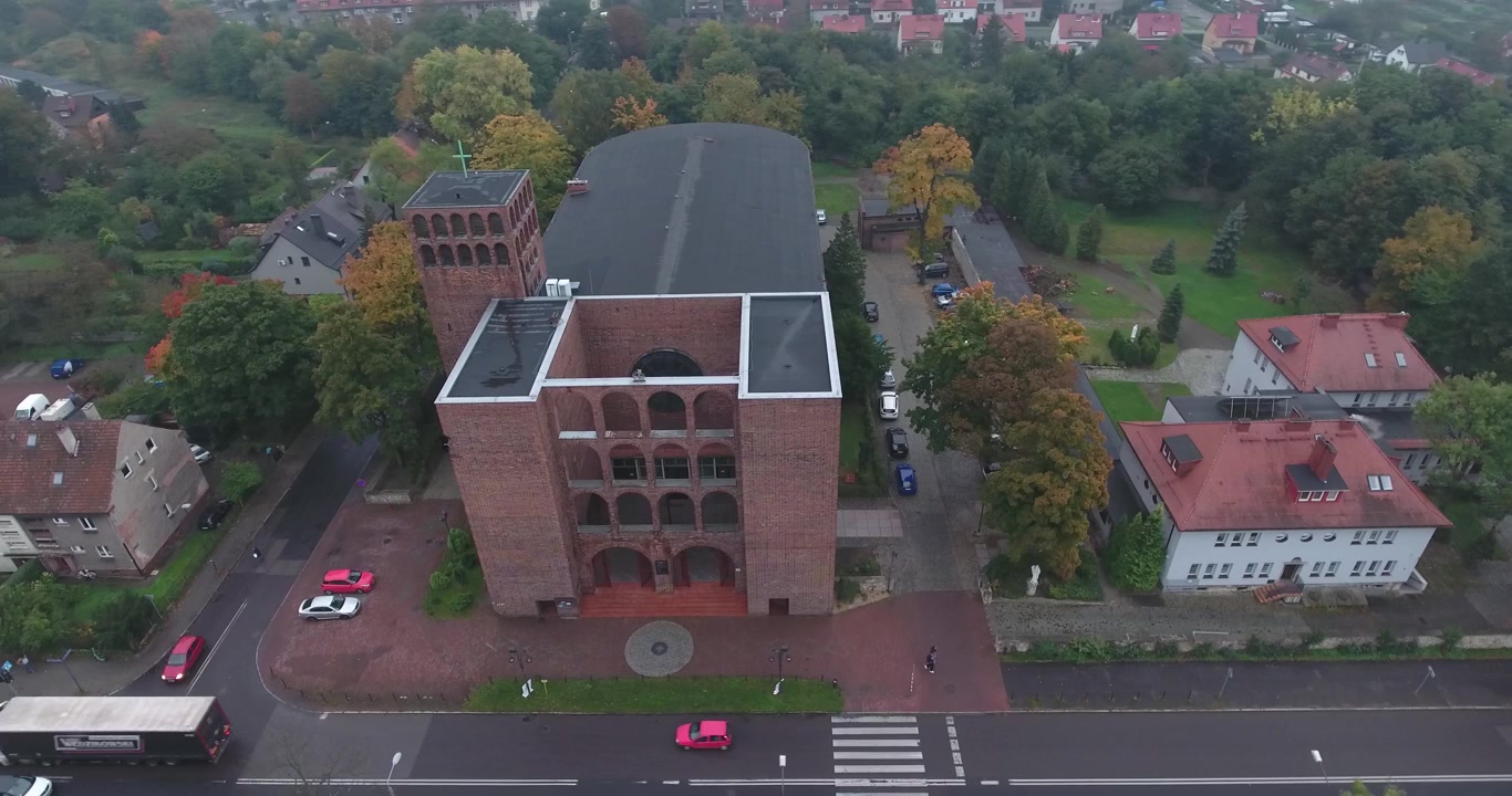 Iglesia en la calle con coches pasando y aparcamiento, Silesia, Polonia, toma 4K