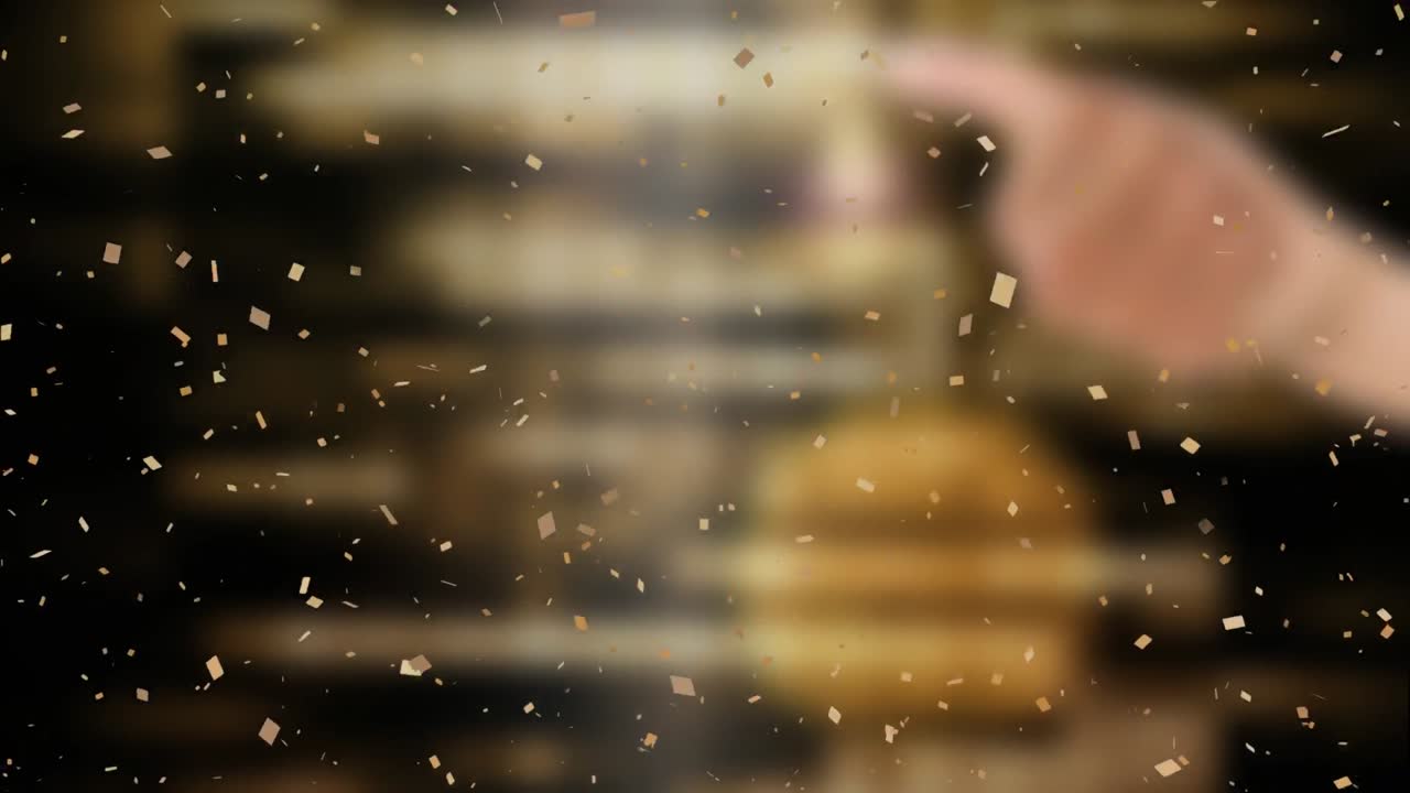 갈색 배경 위에 떨어지는 콘페티의 애니메이션.